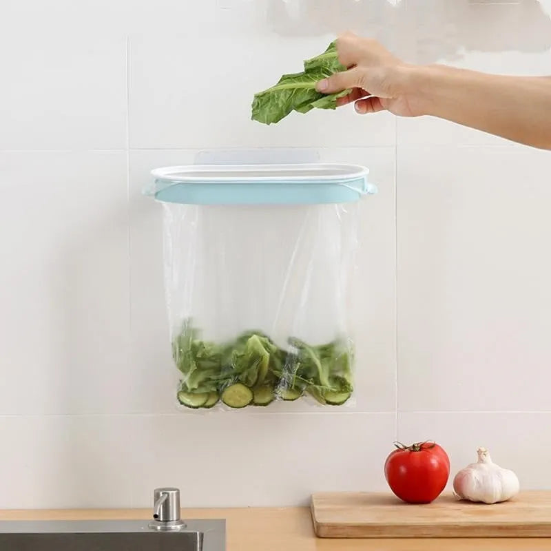 A blue plastic garbage bag storage rack mounted inside a kitchen cabinet door.