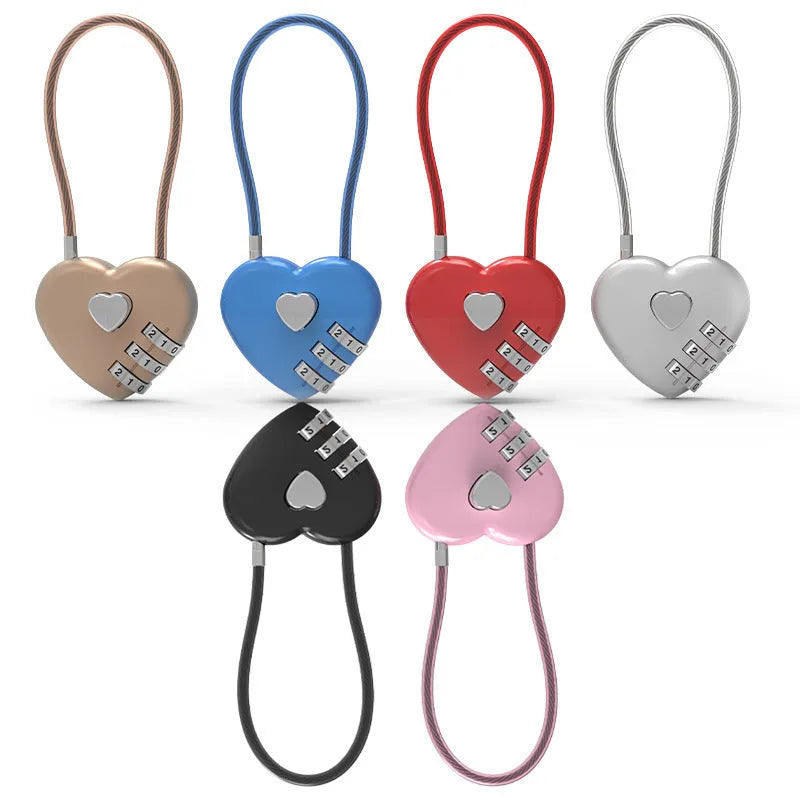 Peach heart shaped combination lock with a black steel rope cable coiled on a table.