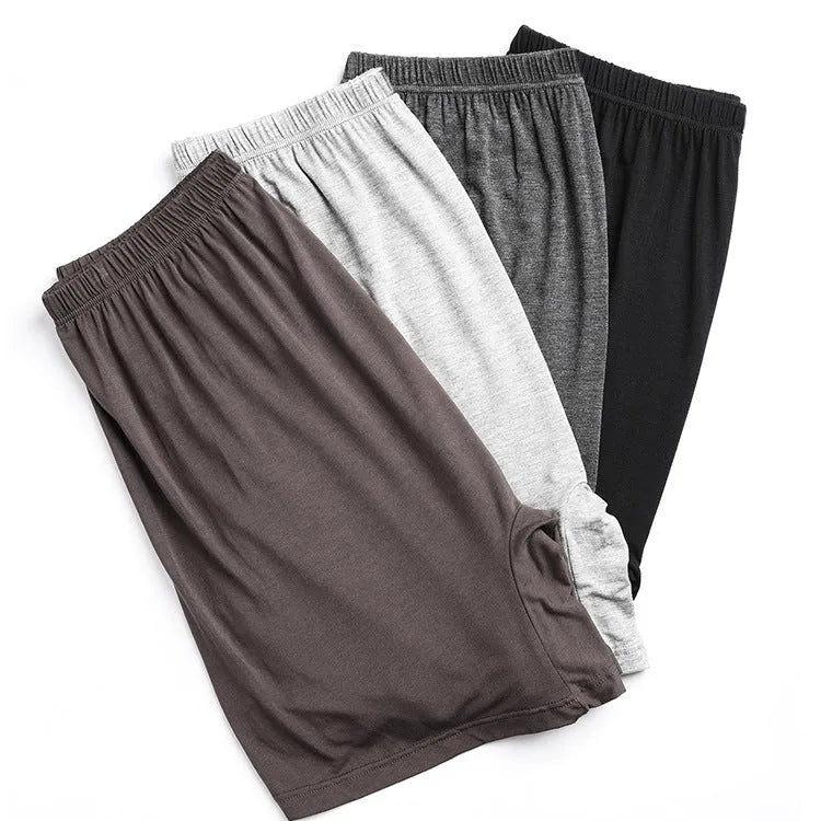 Men's solid colour modal boxers on a white background, showing high-waist design in black, blue, and gray.