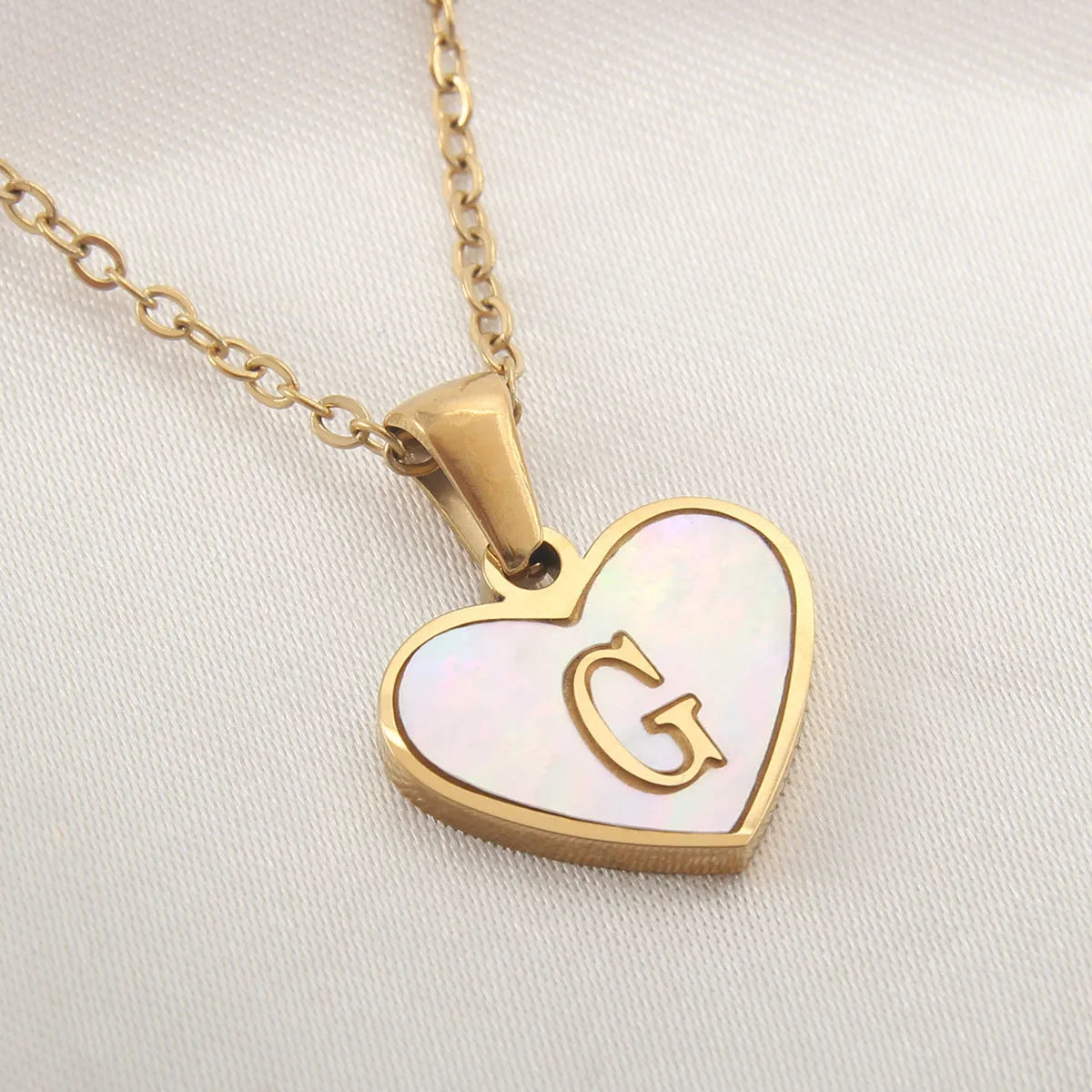 Gold heart necklace with white shell pendant and initial charm on 45cm adjustable chain