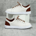 Women's beige brown platform skateboard sneakers with a cross strap and flat rubber sole.