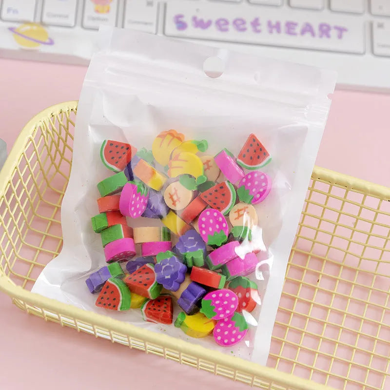 Assortment of fifty small cartoon-shaped rubber erasers in fruit and animal designs.