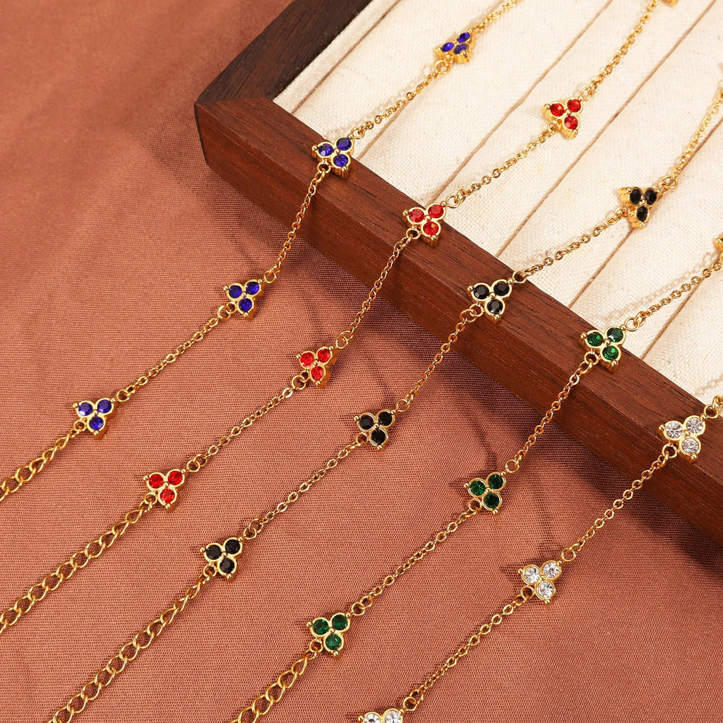 Geometric triangular stainless steel women's bracelet with coloured zircon stones in gold or steel finish.