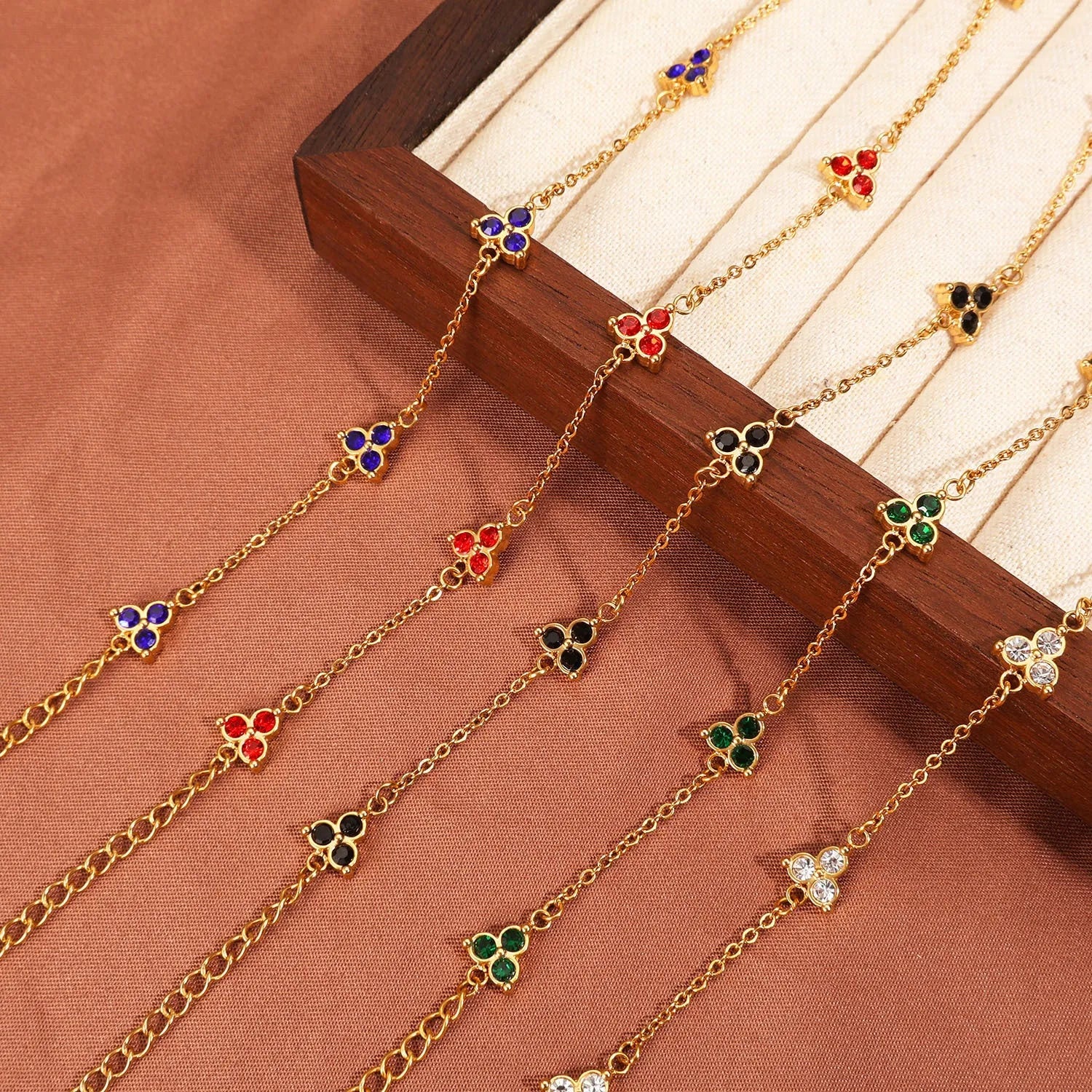 Geometric triangular stainless steel women's bracelet with coloured zircon stones in gold or steel finish.