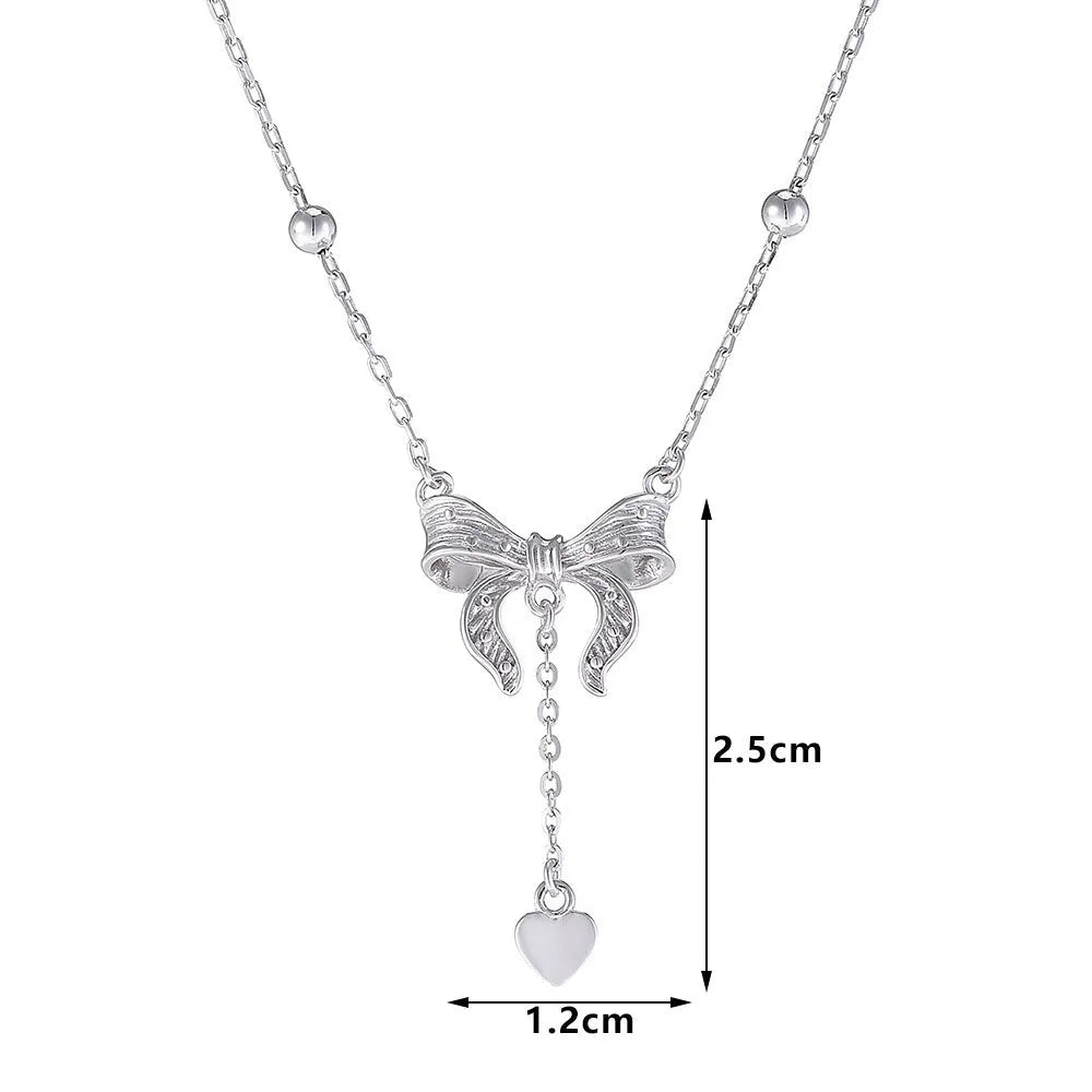 Close-up of a silver heart pendant necklace with butterfly detail on a 40-45cm O-ring chain.