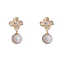 Pair of gold-plated copper earrings with metal petal design and faux pearl accents for women