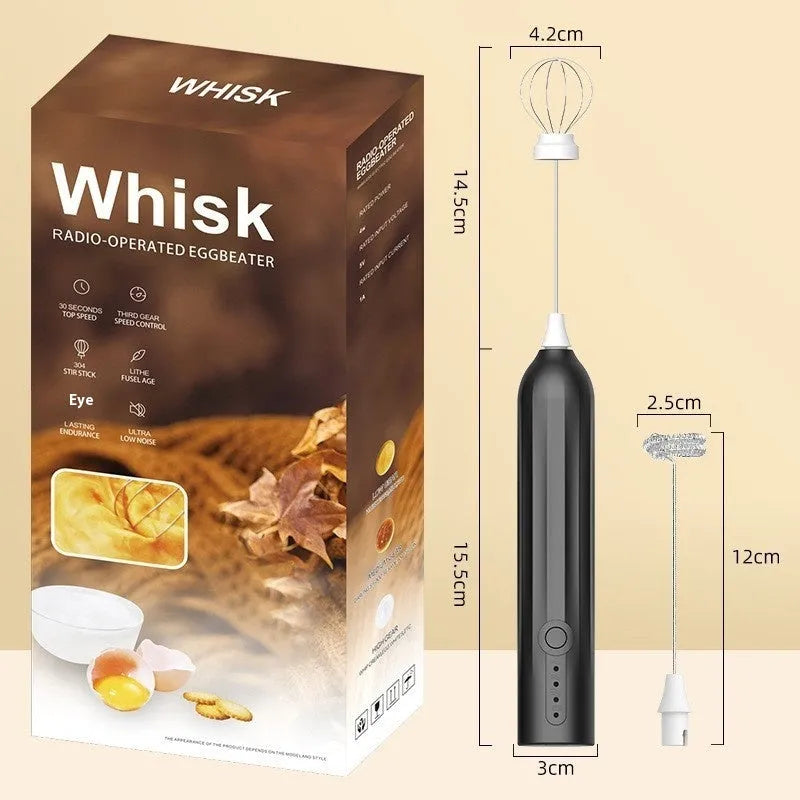 Compact black handheld milk frother with stainless steel whisk on a kitchen counter.