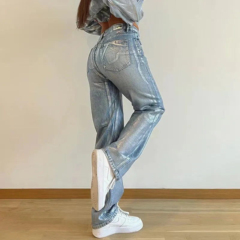 Blue high waist straight-leg denim jeans with contrast details on a neutral background.