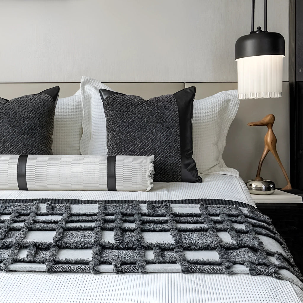 Grey and white plaid bed runner blanket with leather round pillow on 1.5m bed