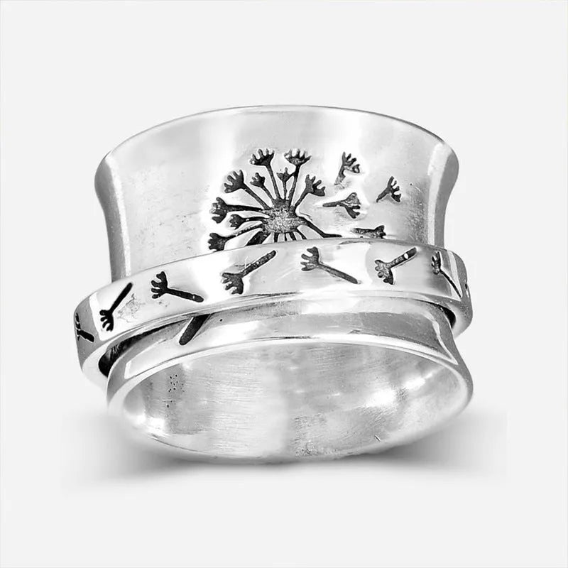 Silver rotatable floral fashion ring showing adjustable flower element on band