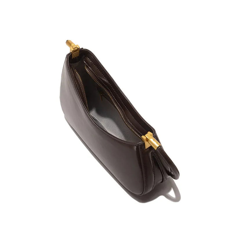 Retro oval women's underarm bag in PU leather with a single shoulder strap and zip pocket.