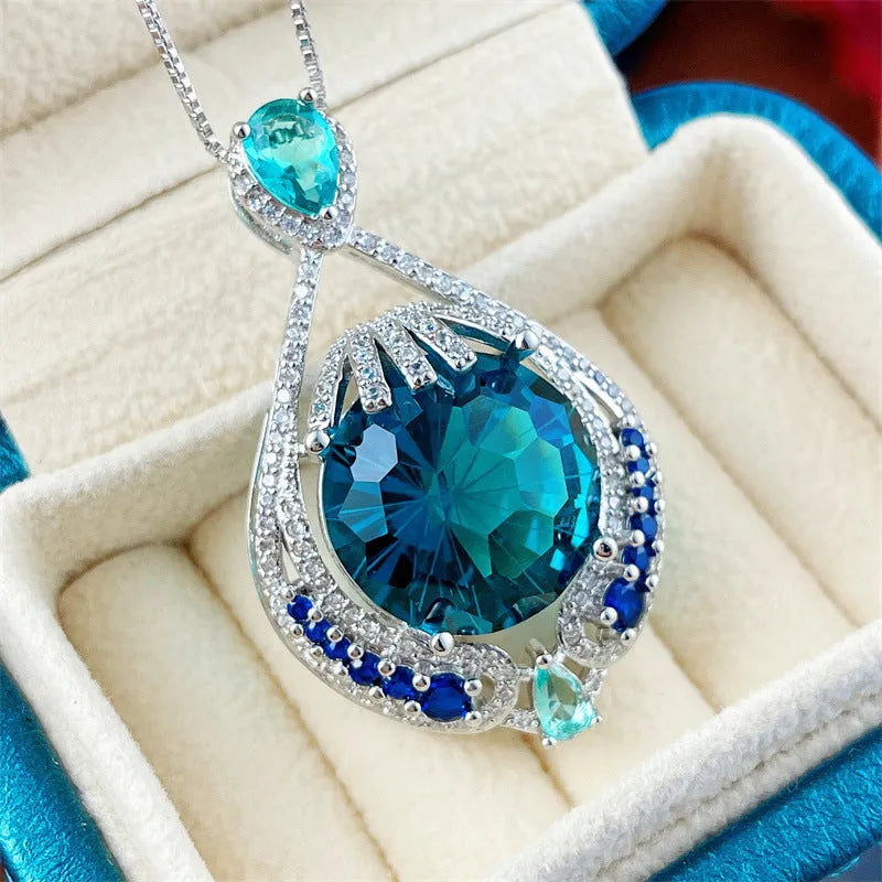 Geometric women's necklace with blue crystal pendant on water wave chain