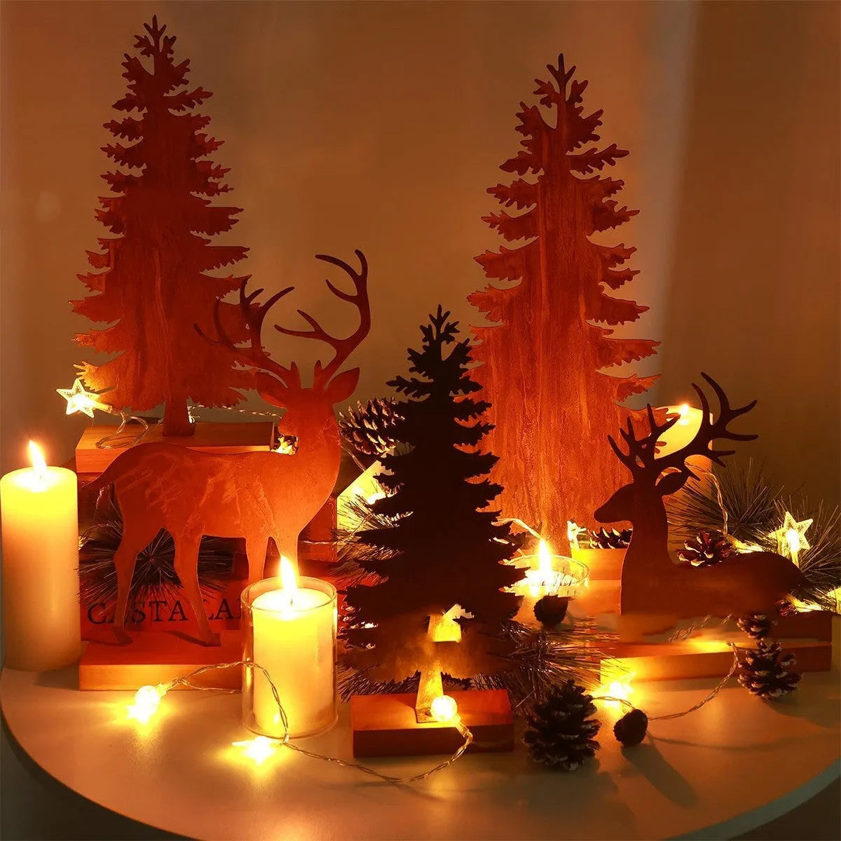 Three metal Christmas tree ornaments with elk figurines and rustic metallic finish