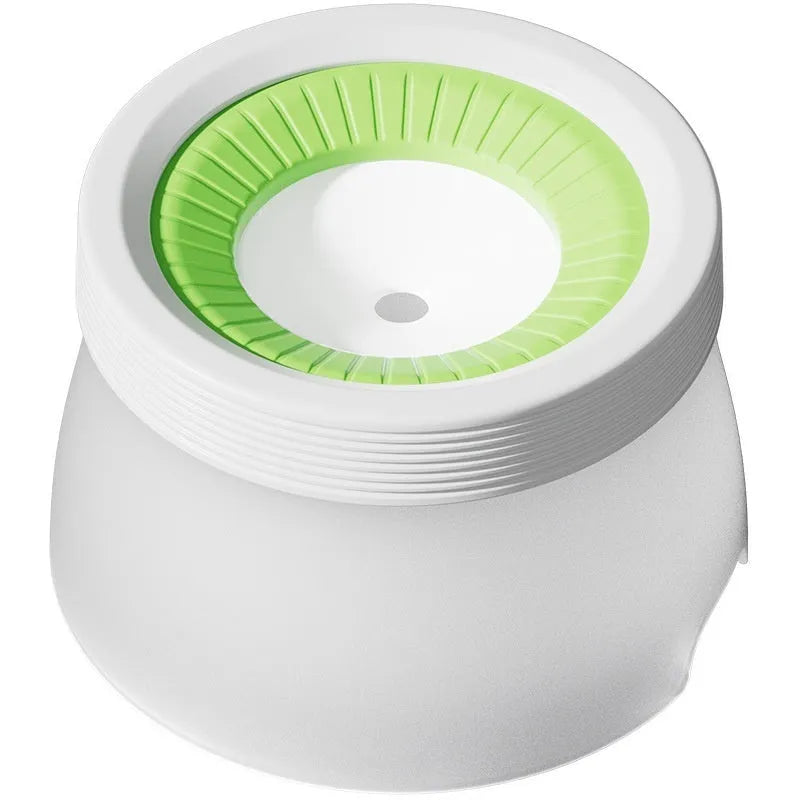 Green elevated pet water bowl with suspension stand next to a drinking cat