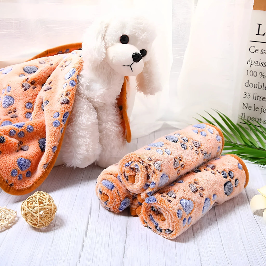 Coral fleece dog blanket with paw print design, shown in camel colour, size L (100x120 cm).