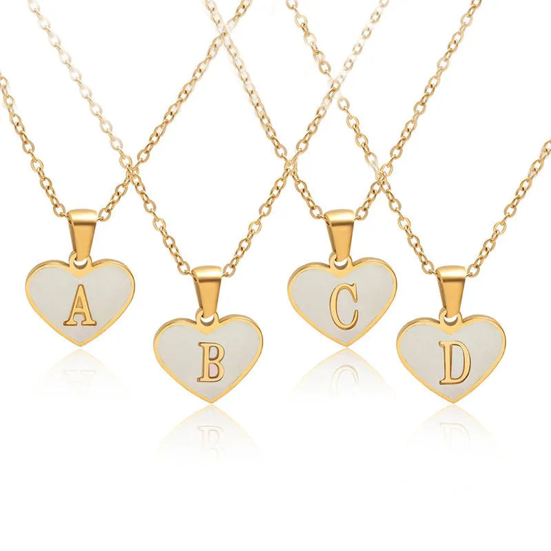 Gold heart necklace with white shell pendant and initial charm on 45cm adjustable chain