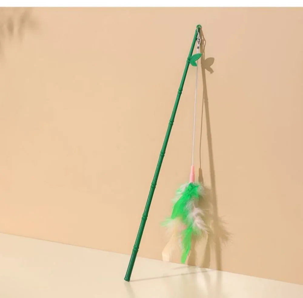 Green interactive cat feather wand toy with bells and feathers on a durable string