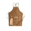 Canvas apron with cross-back straps in camel colour, shown laid flat