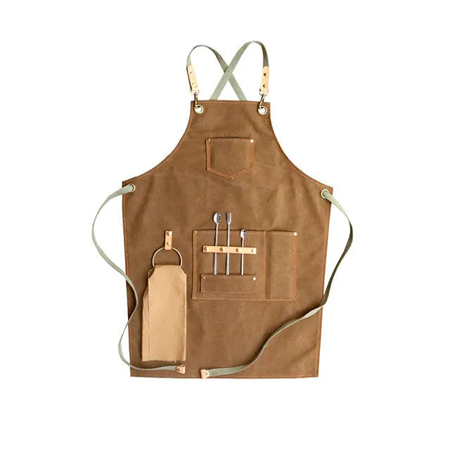 Canvas apron with cross-back straps in camel colour, shown laid flat