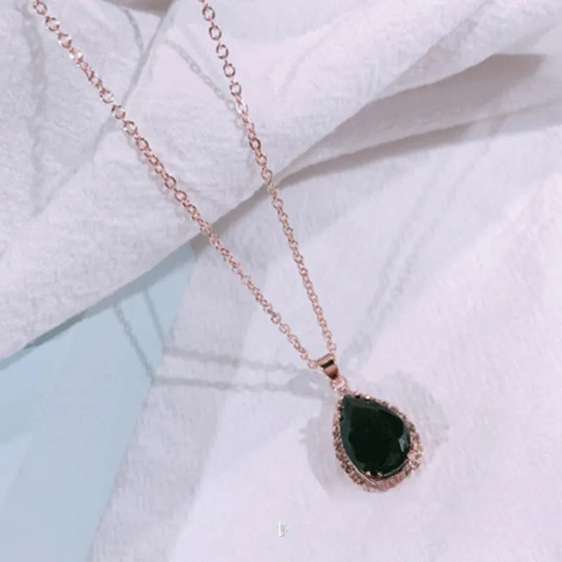 Women's pink rhinestone drop necklace with rose gold electroplated finish and geometric design