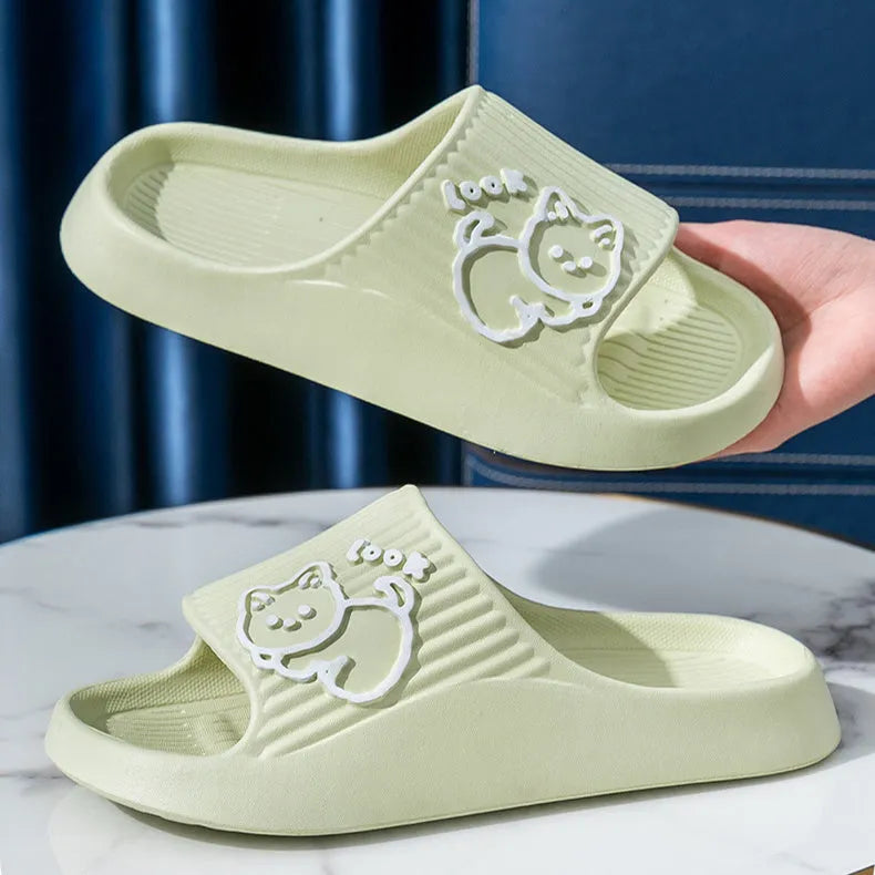 Women's green cat slippers with thick EVA platform sole on a wooden floor
