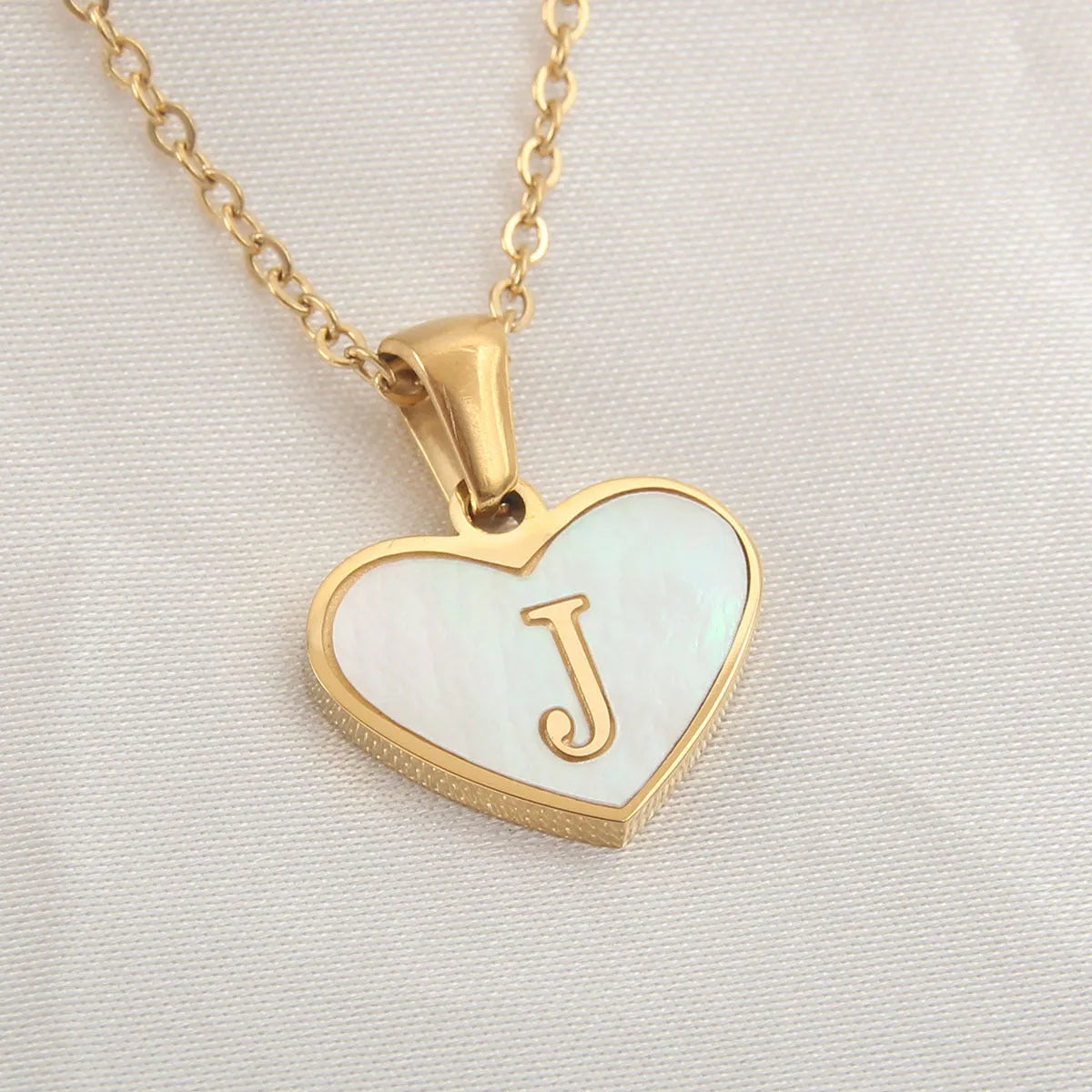 Gold heart necklace with white shell pendant and initial charm on 45cm adjustable chain