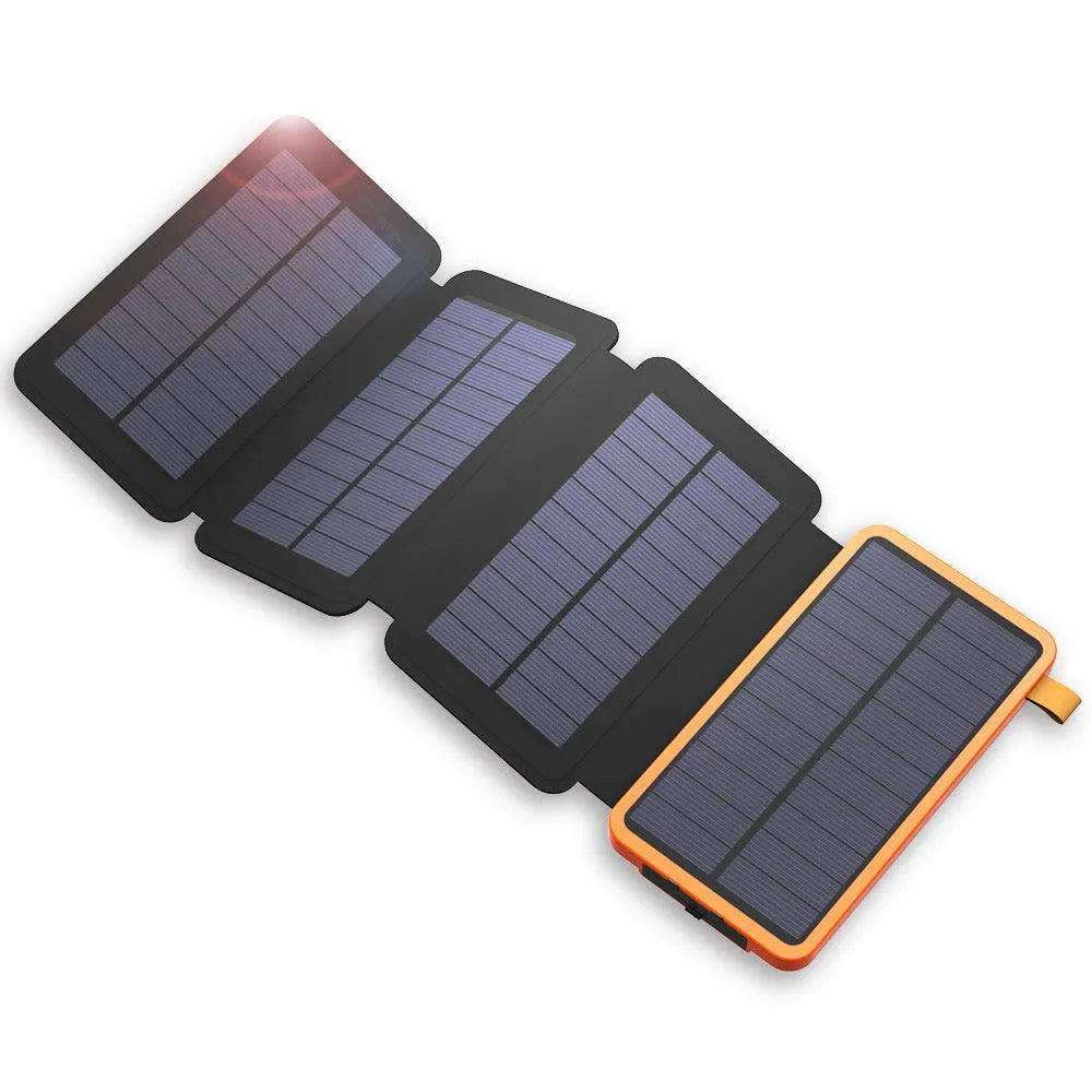 Black solar power bank with a solar panel, LED light, and soft leather exterior, shown outdoors.
