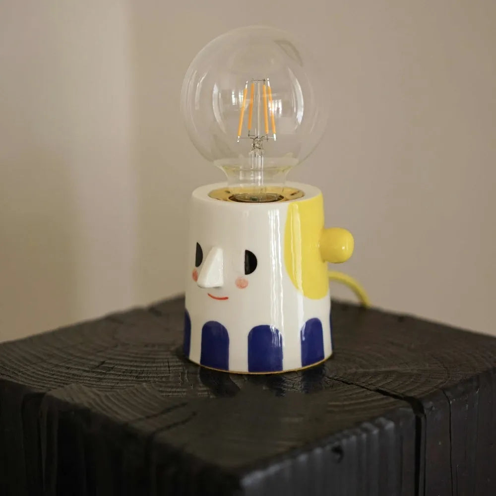 Handmade ceramic bedside lamp with ball headlight colour on wooden table