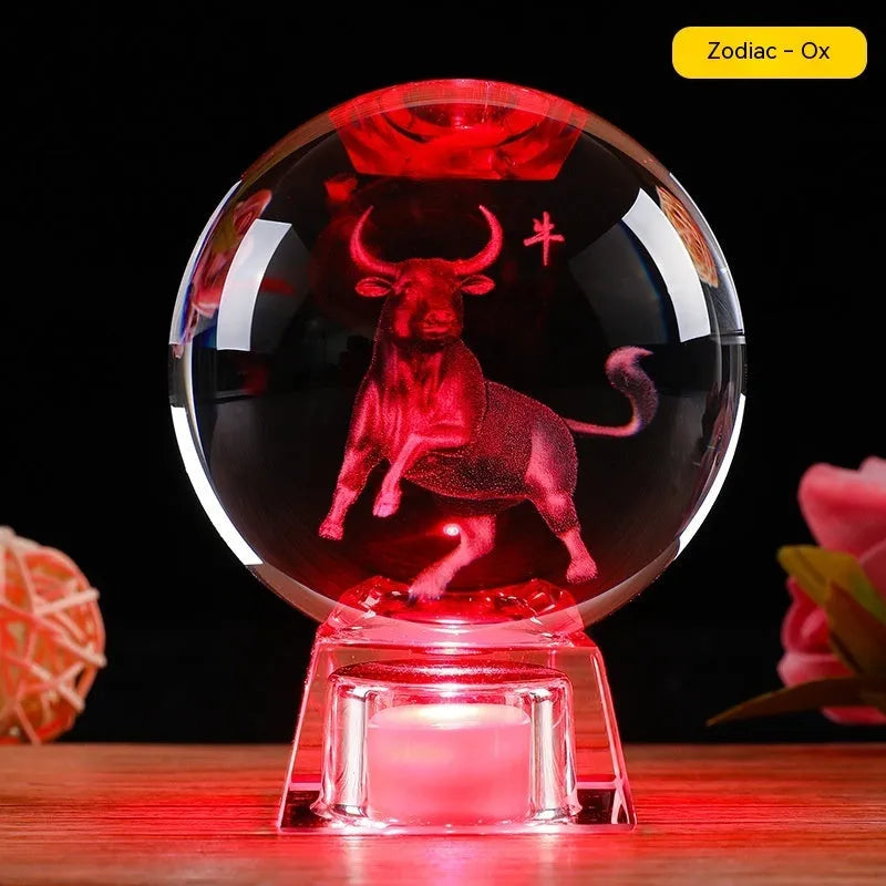 White crystal ball luminous ornament with Chinese zodiac animal design on an electronic charging base.