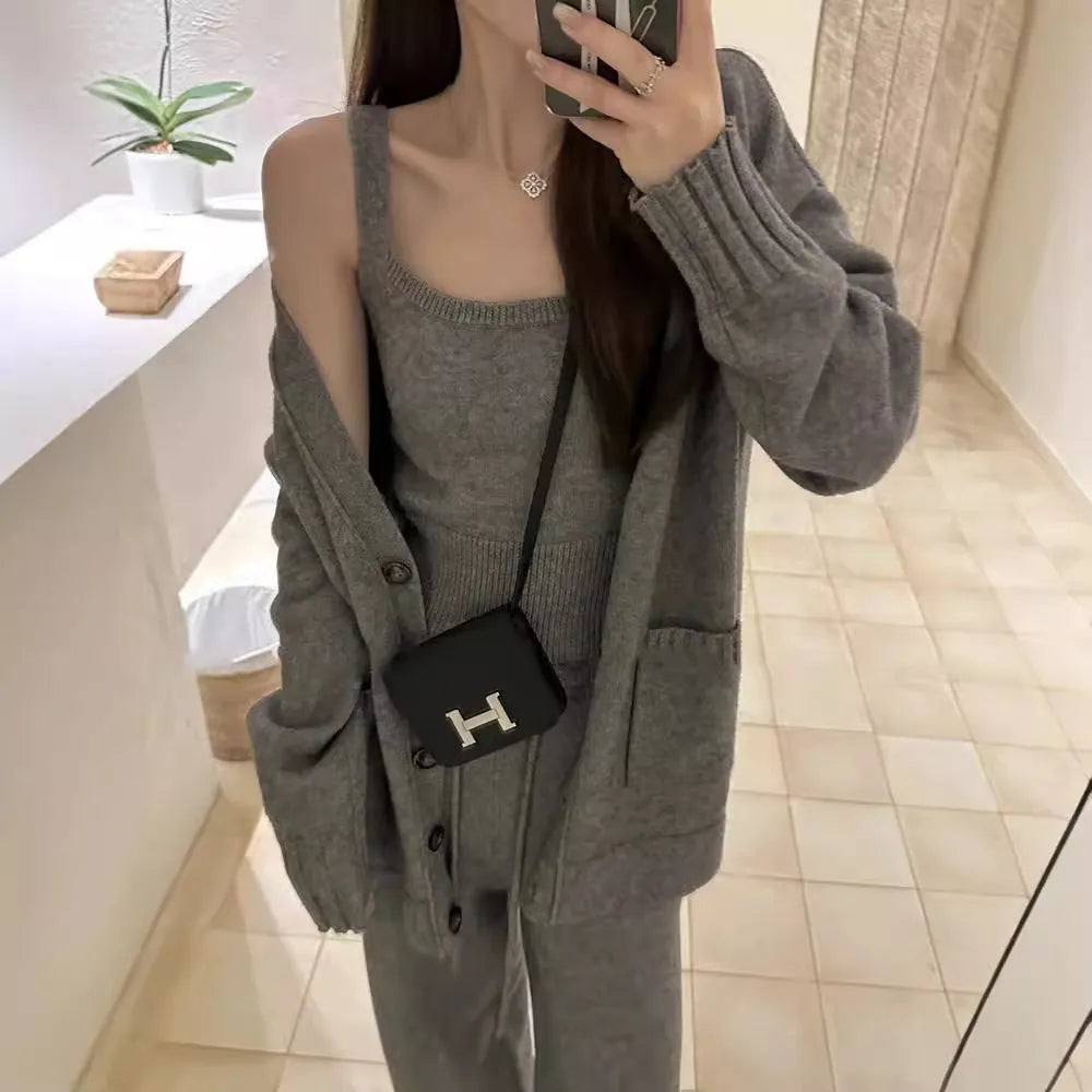 Women's light brown knit cardigan three-piece set with suspender casual pants on a hanger.