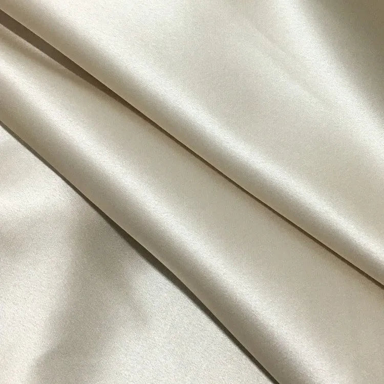 Solid colour mulberry silk envelope pillowcase in dark grey on a bed.