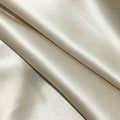 Solid colour mulberry silk envelope pillowcase in dark grey on a bed.
