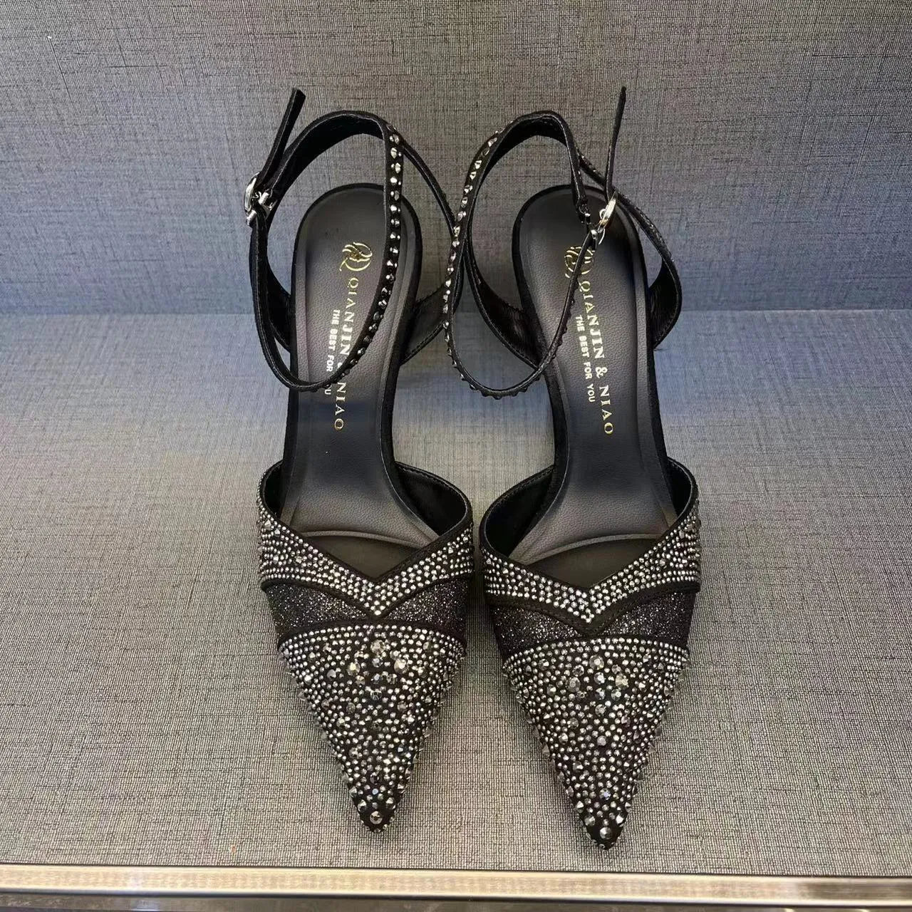 Women's black high heels with hollow stiletto heels and red soles, pointed toe design