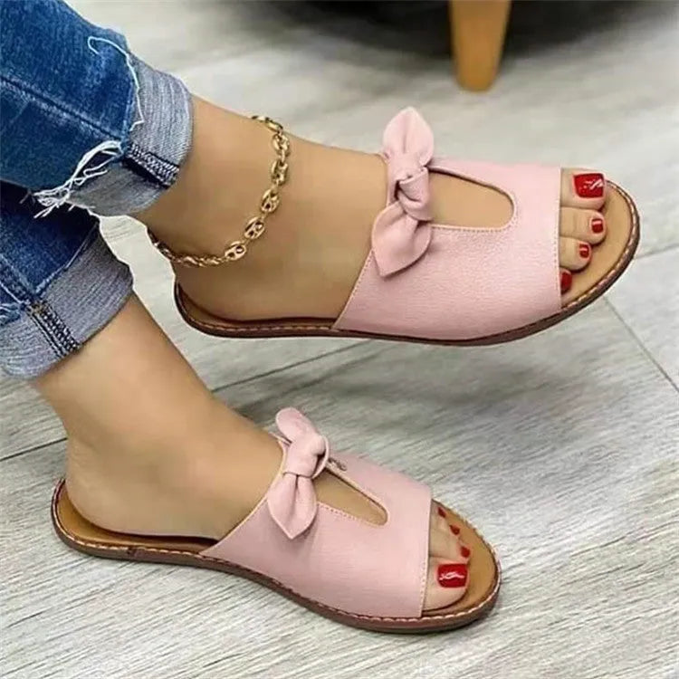 Ladies' black sandals with a fish mouth toe design and a decorative bow on the strap.