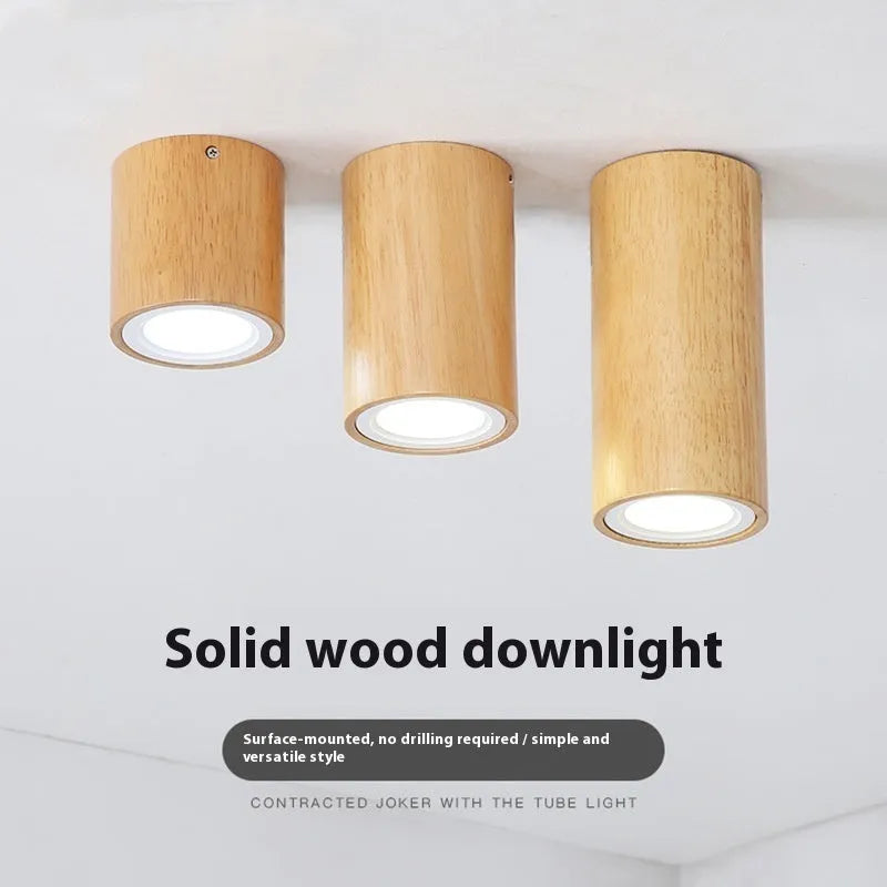 Modern solid wood surface mounted downlight in wood colour, shown in round and square designs for corridor or entrance ceilings.