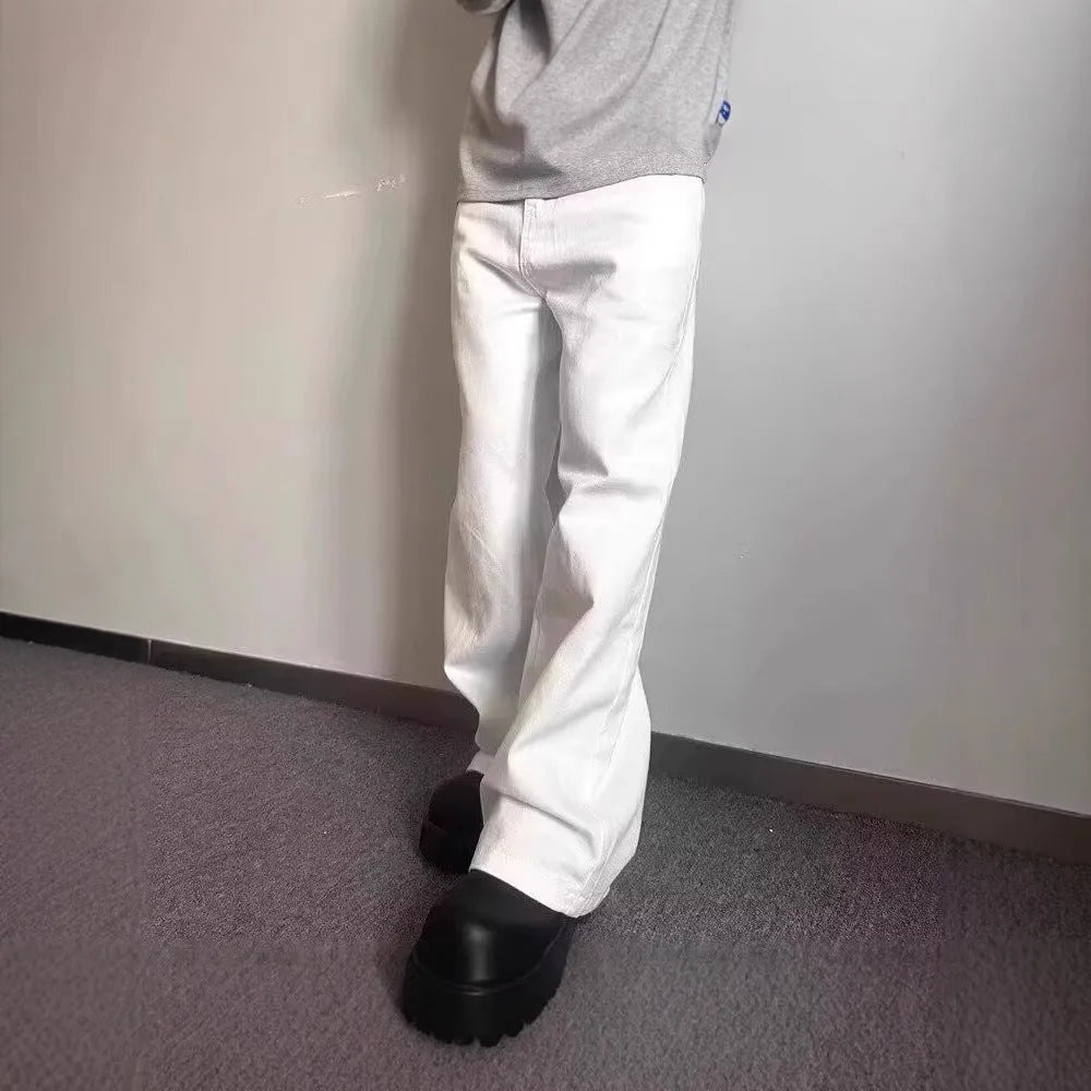 A pair of men's straight-leg white jeans with a mid-rise waist and zipper fly on a plain background.