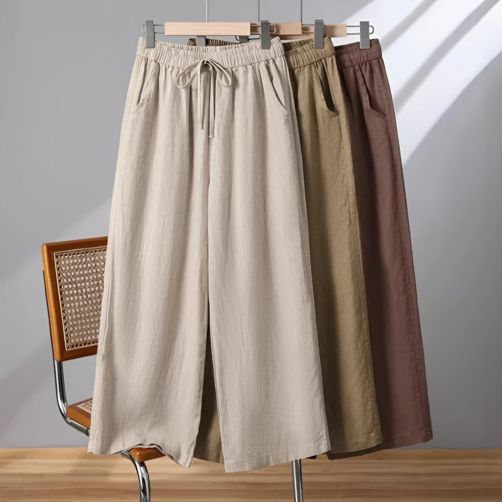 Women's straight leg casual trousers in khaki with an elastic waistband and lace-up drawstring detail.