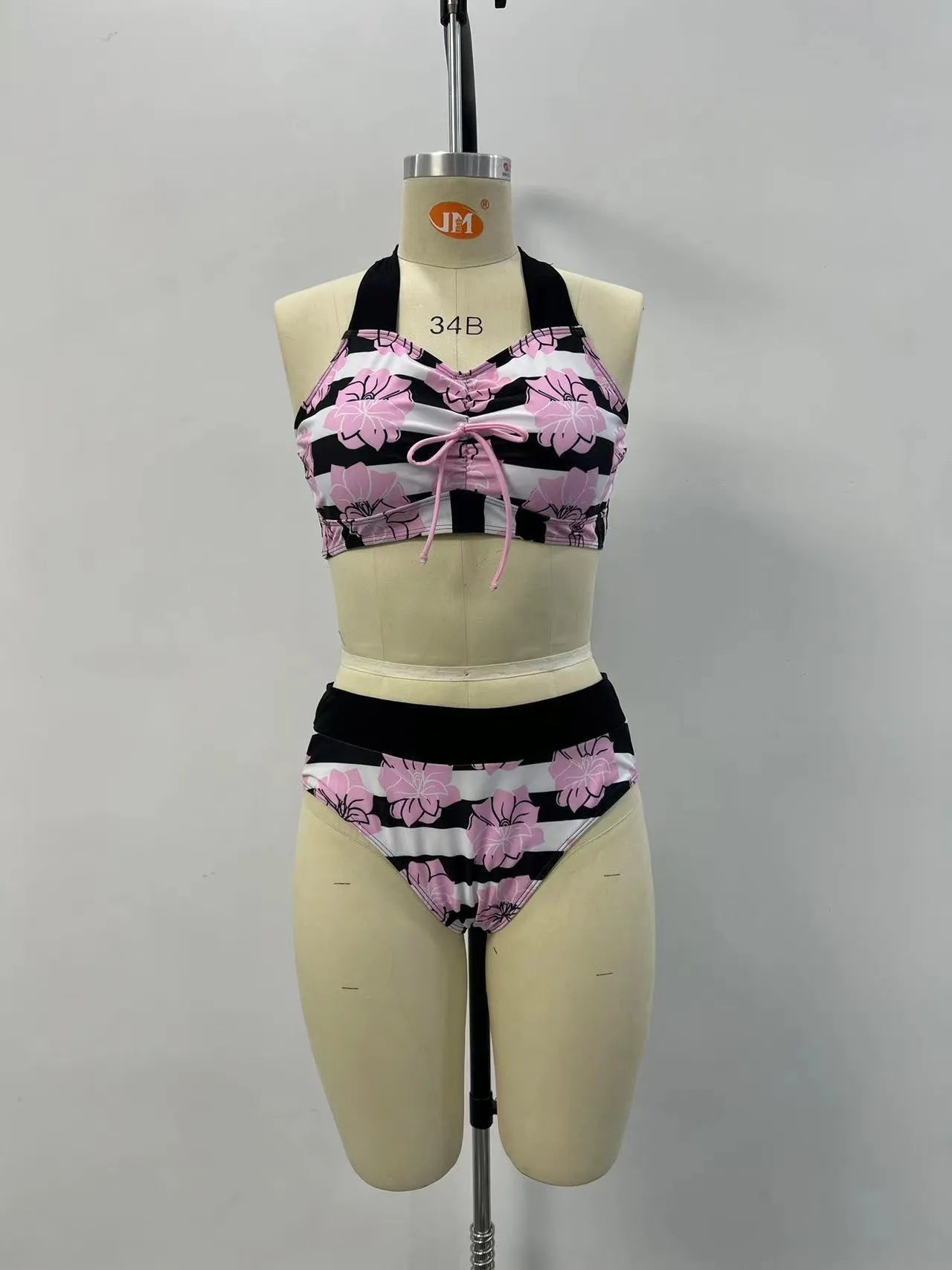 Black women's bikini with printed design, belly coverage and split leg style for swimming.