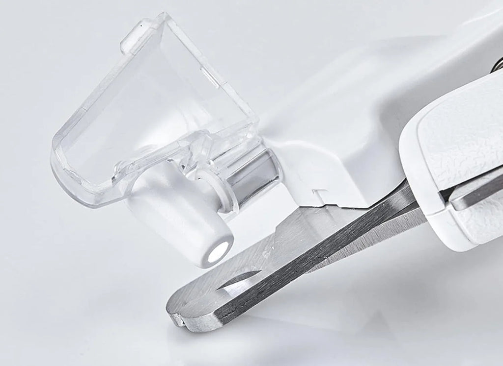 White LED pet nail clippers with transparent guard, triangular blade, and anti-slip handle next to a filing tool.