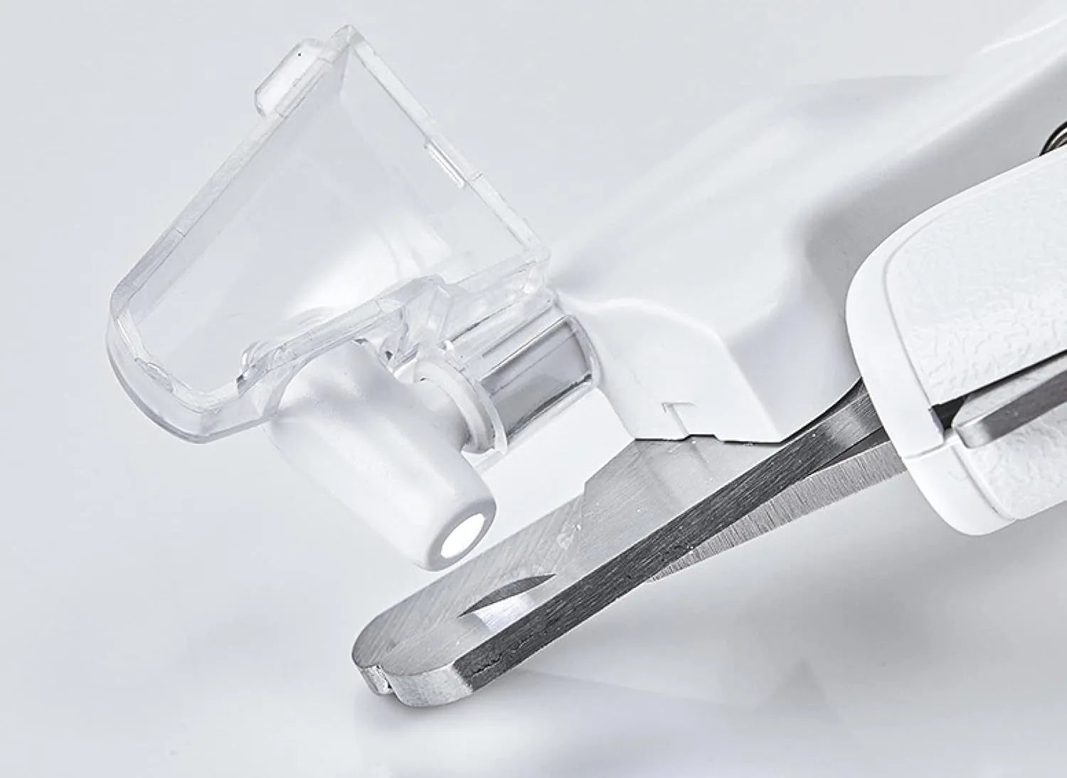 White LED pet nail clippers with transparent guard, triangular blade, and anti-slip handle next to a filing tool.