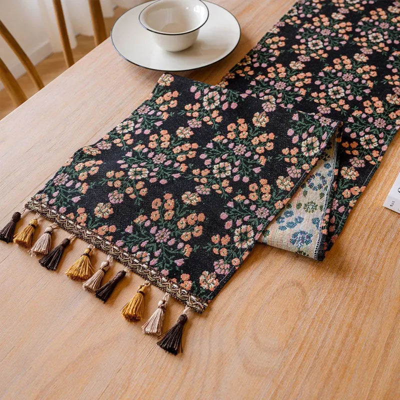 Nordic jacquard bouquet pattern table runner with striped design and decorative tassel fringe in dark blue