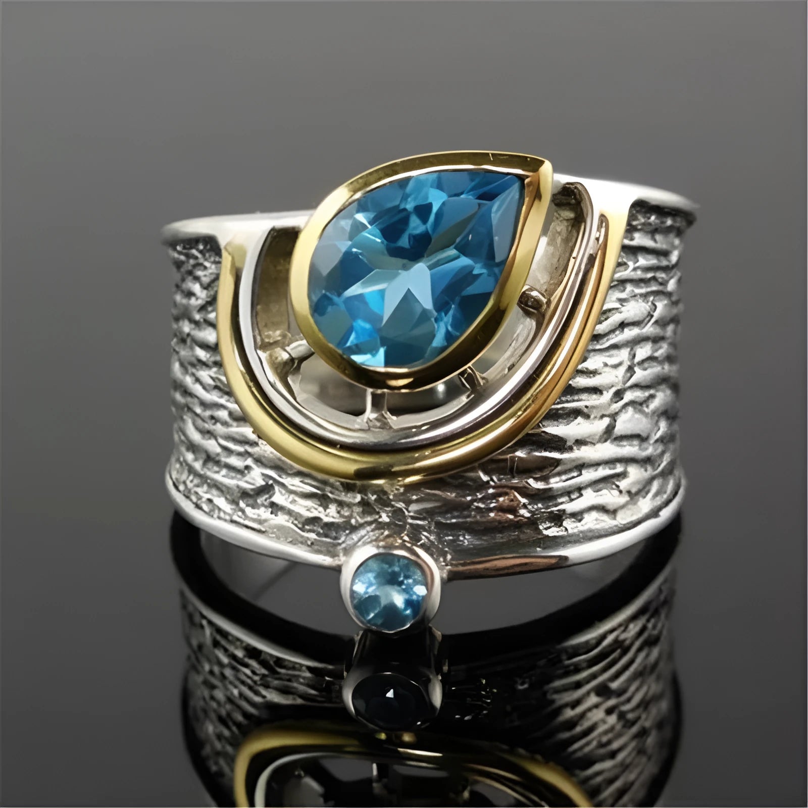 Close-up of a women's blue zircon alloy ring with a drop shape and Chinese-inspired design on a hand.