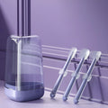 Silicone pet toothbrush for cats and dogs in blue, green, and purple colours for dental care.