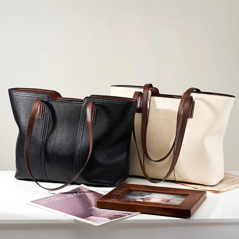 Black genuine leather women's shoulder bag showing multiple internal compartments and single strap