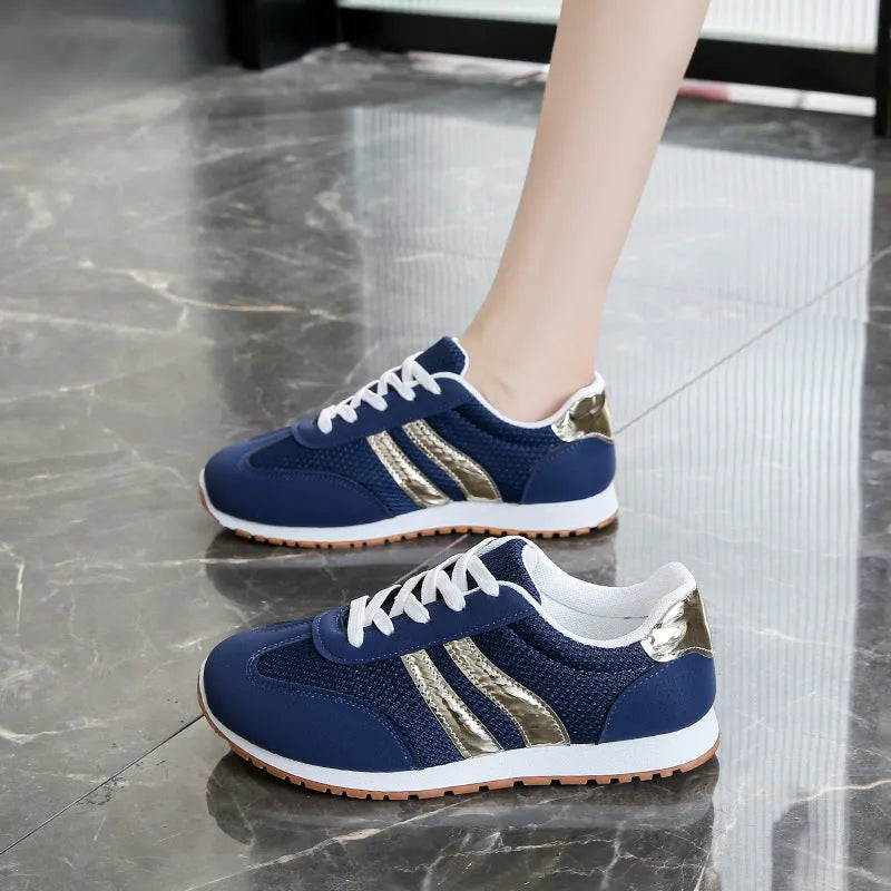 Blue women's casual tennis shoes with cross shoulder straps and a flat rubber sole