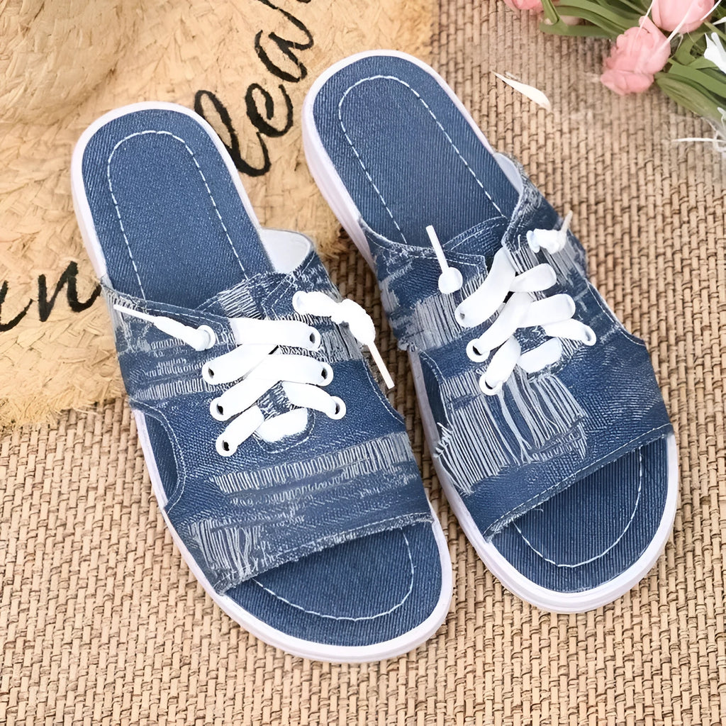 Blue women's flat canvas roman slippers with cloth lining and a rubber sole.