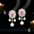 Oval-shaped copper earrings with inlaid zircon and a dangling pearl tassel in light purple.