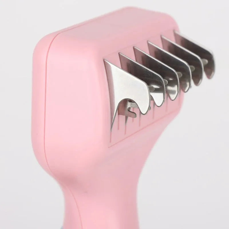 Pink dual-ended pet grooming brush with stainless steel knot knife and massage pins on a white background