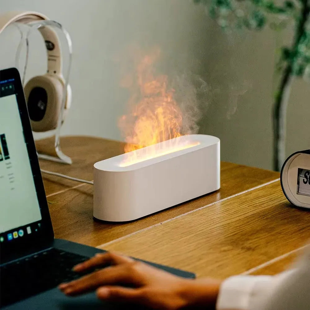 Square-shaped lava lamp-style USB aroma diffuser humidifier with colourful flame light effect on a desk.