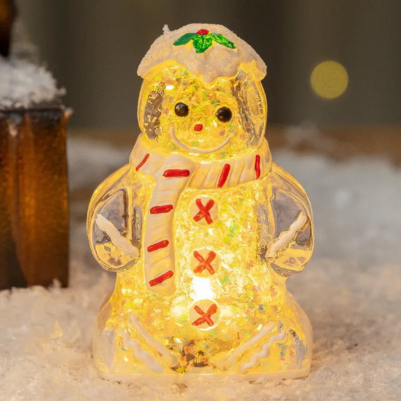 Glowing red-scarf gingerbread man Christmas ornament with modern design on a green tree branch.